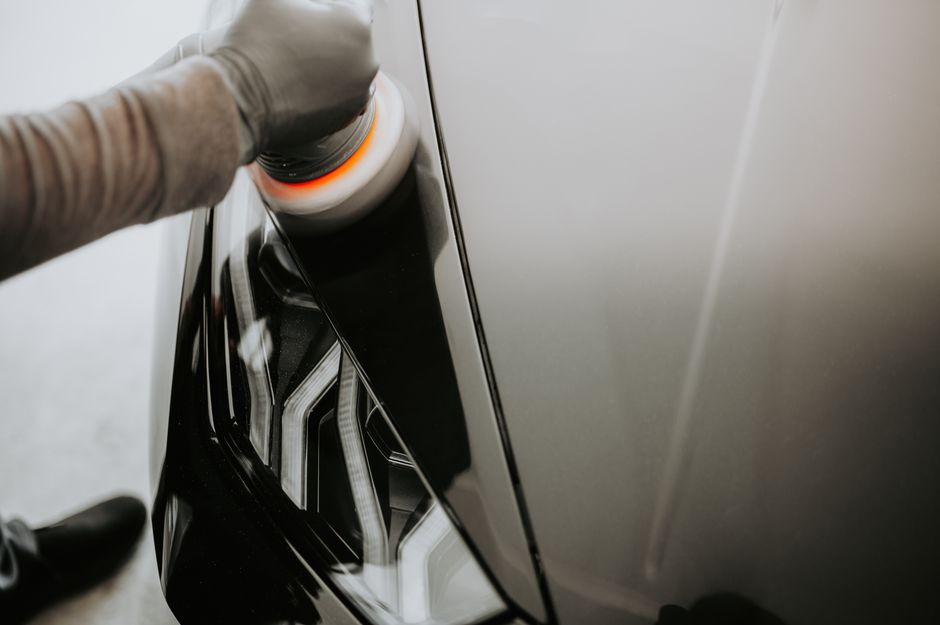 Applying protective wax to car paint