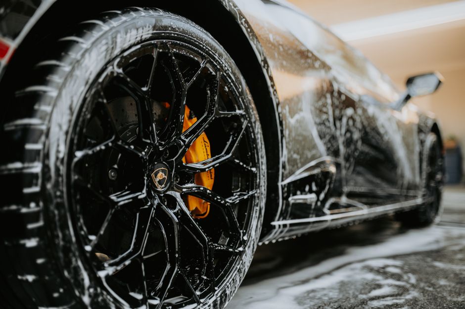 A shiny luxury vehicle receiving a premium car wash